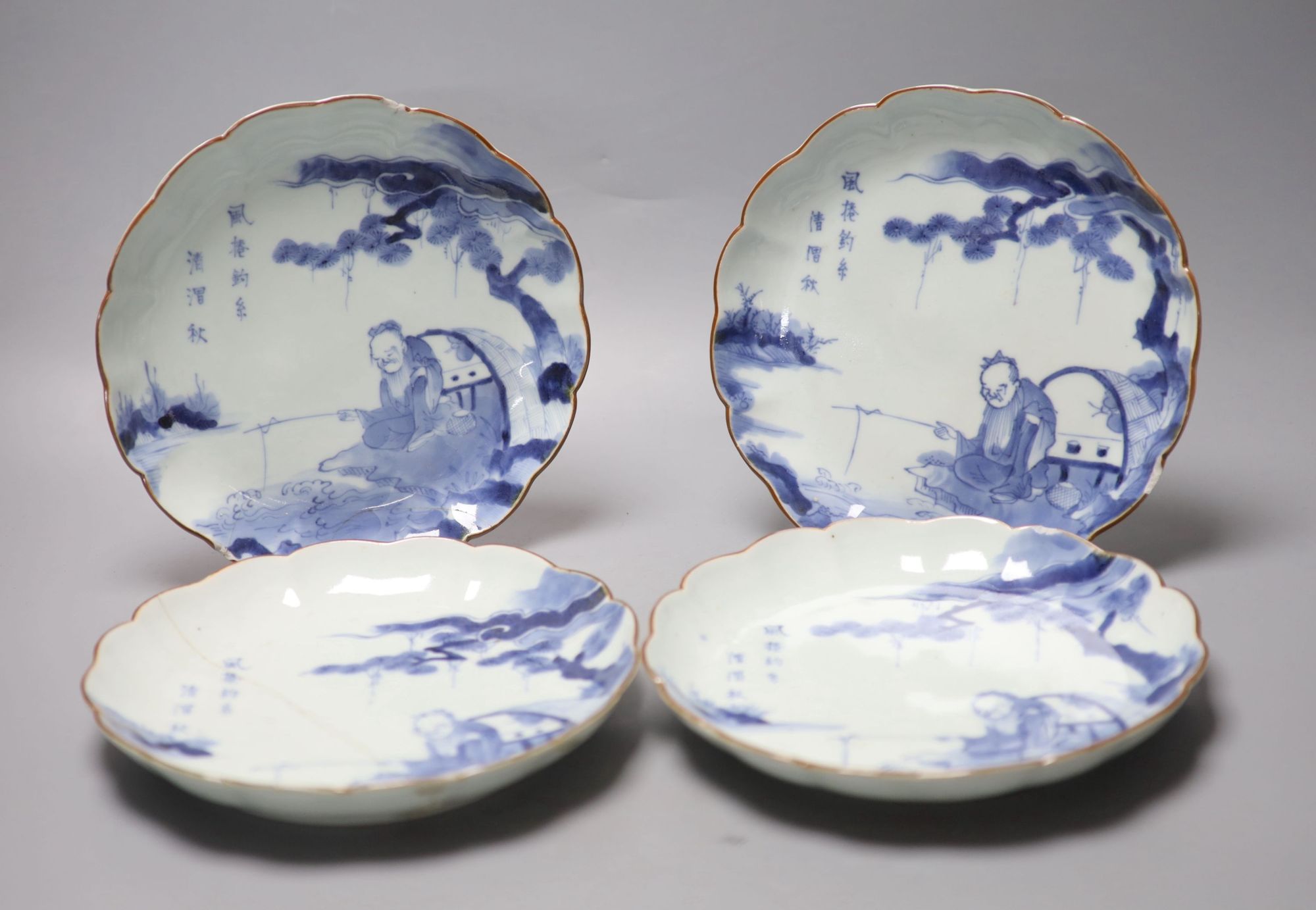 A set of four 17th century Japanese Arita blue and white plates, diameter 21cm